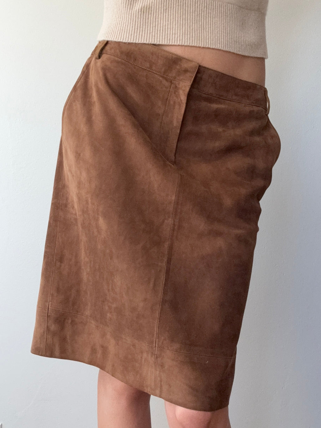 Brown fabric swatch held by a person against a plain background