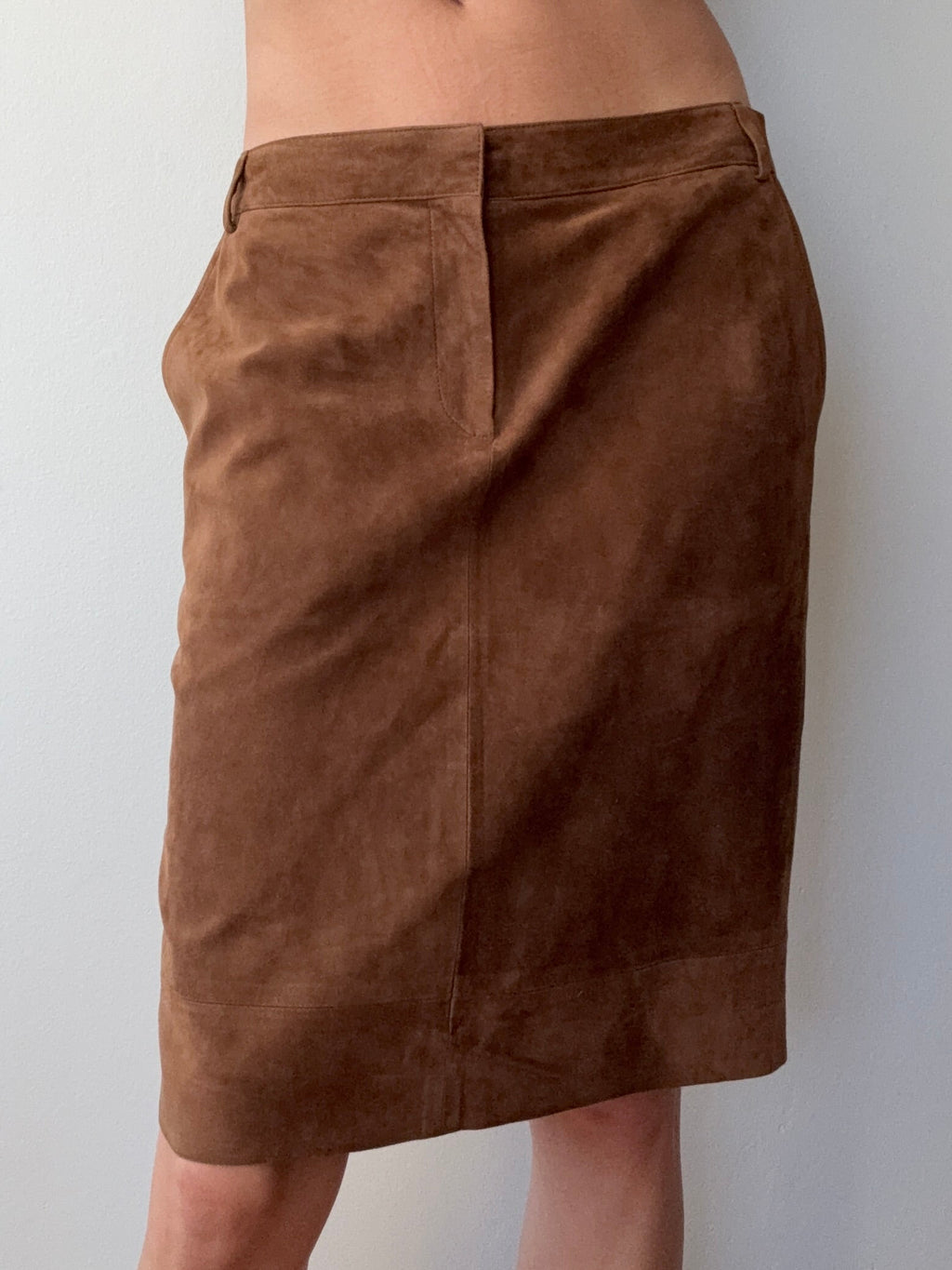 Brown pants being worn by a person against a plain background