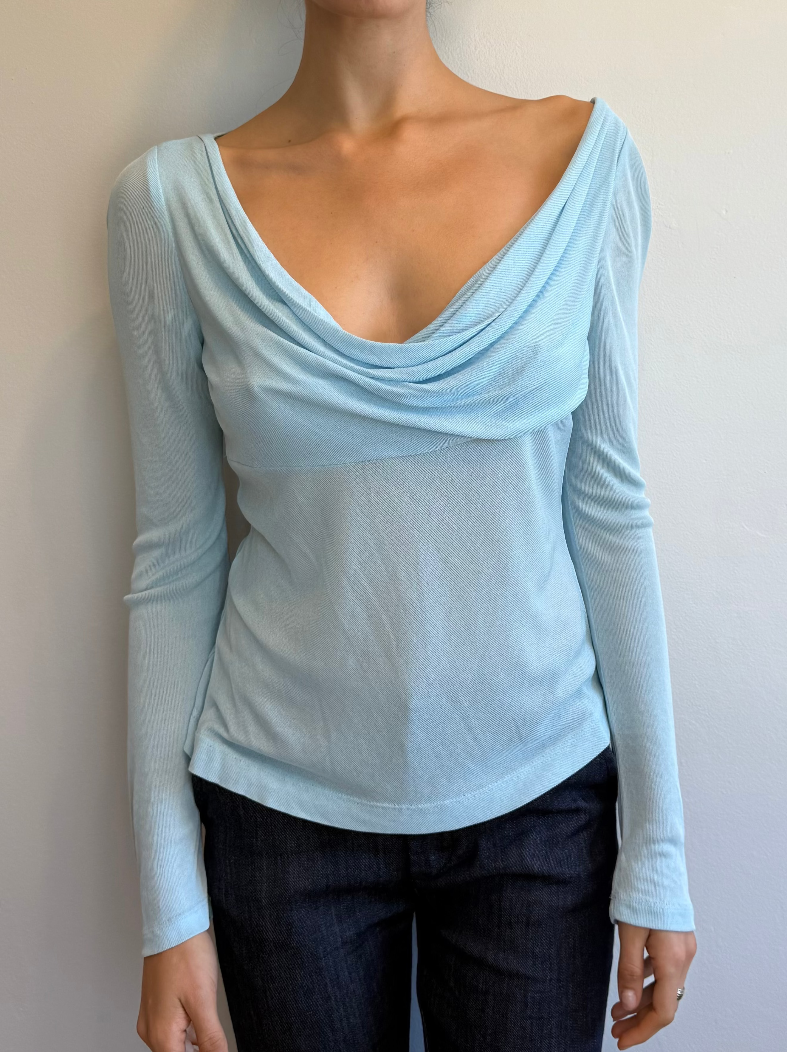 Light blue long-sleeve top worn by a person on a plain background