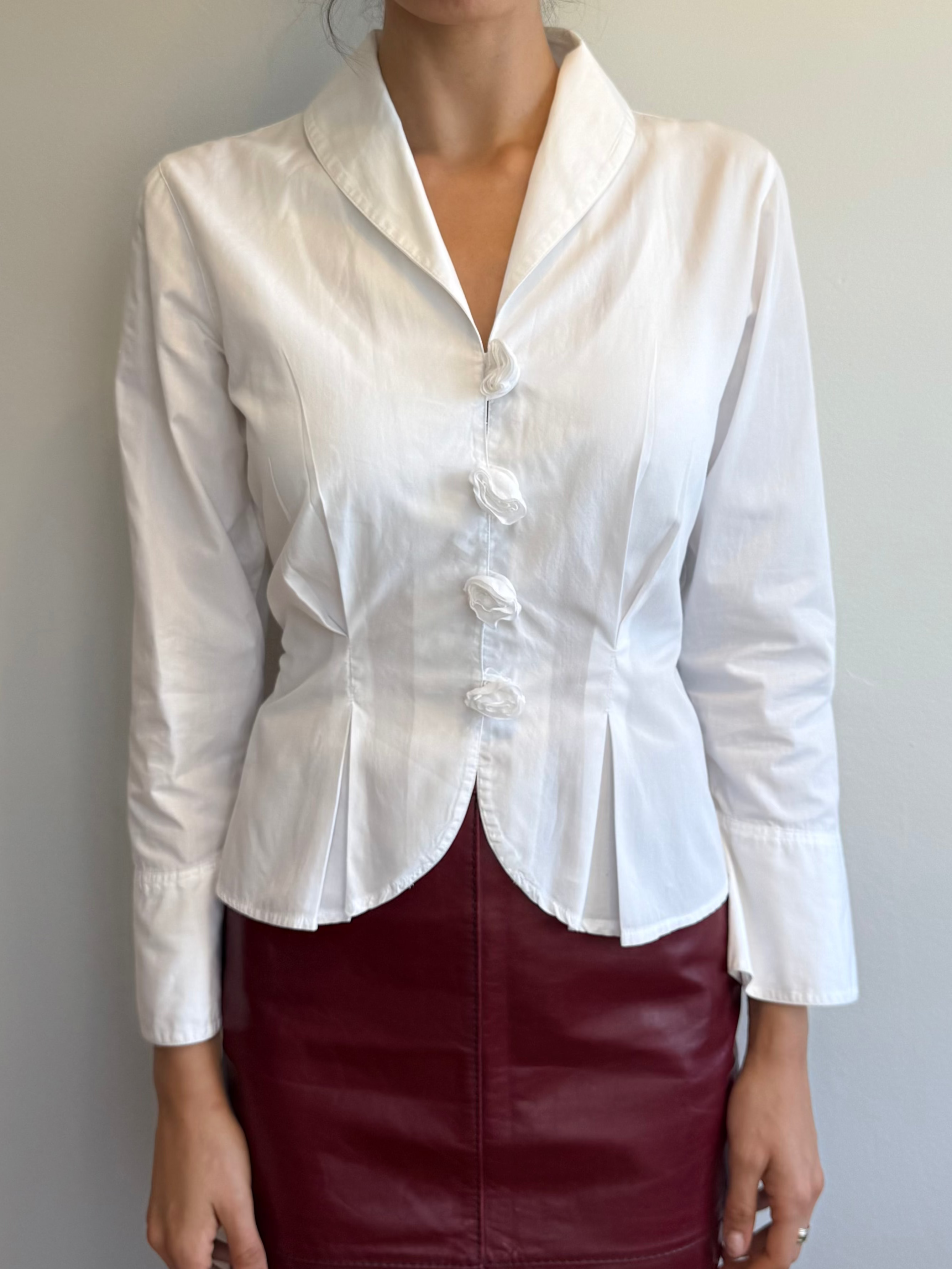 White blouse with a collar and burgundy skirt on a plain background