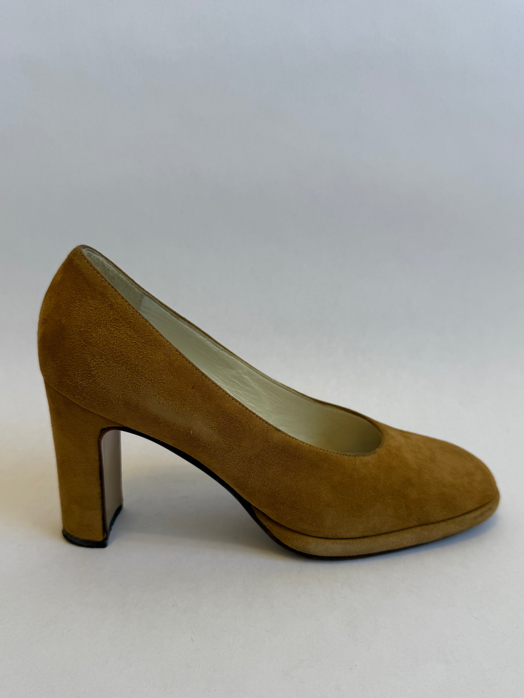 Brown suede high-heeled shoe on a white background